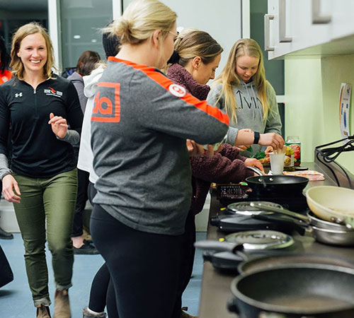 group of athletes cooking